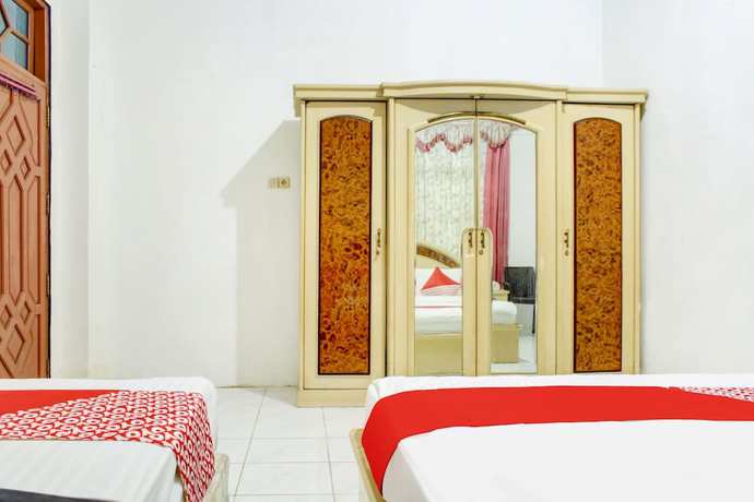 Imagen de la habitación del Hotel OYO 2301 Hocky Guest House. Foto 10