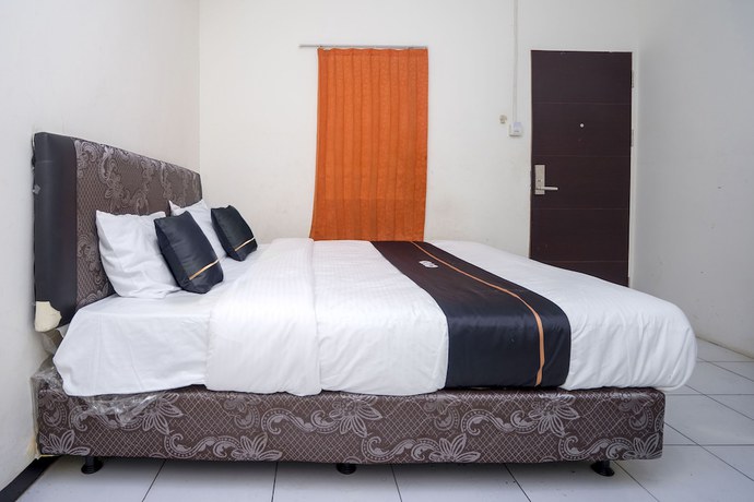 Imagen de la habitación del Hotel OYO 2695 D\'es Guest House. Foto 15