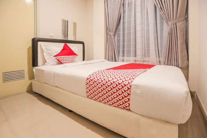 Imagen de la habitación del Hotel OYO 387 Alfa Guest House. Foto 16