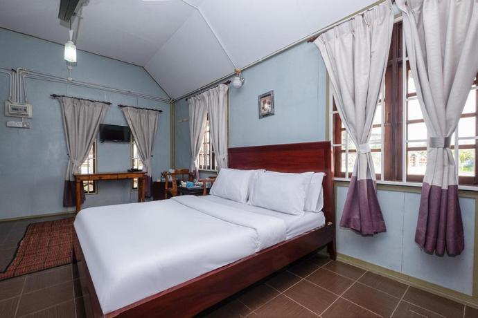 Imagen de la habitación del Hotel OYO 89873 Nurbayu Chalet. Foto 7