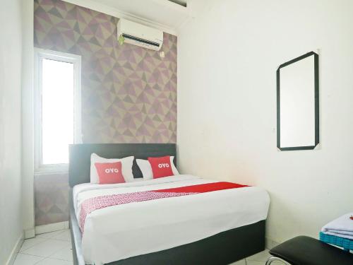 Imagen de la habitación del Hotel OYO 90492 Papi Inn Guesthouse. Foto 20