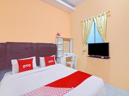 Imagen de la habitación del Hotel OYO 90615 Jojo Homestay. Foto 20