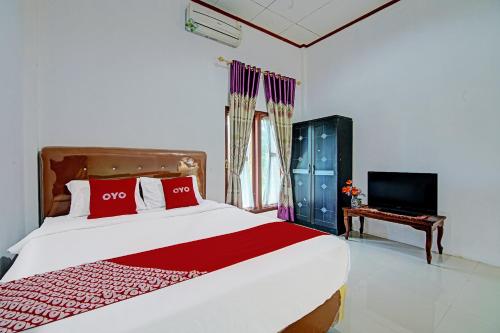 Imagen de la habitación del Hotel OYO 91852 Prima Guesthouse Syariah. Foto 19