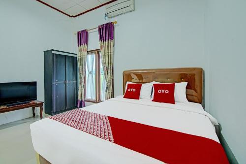 Imagen de la habitación del Hotel OYO 91852 Prima Guesthouse Syariah. Foto 20