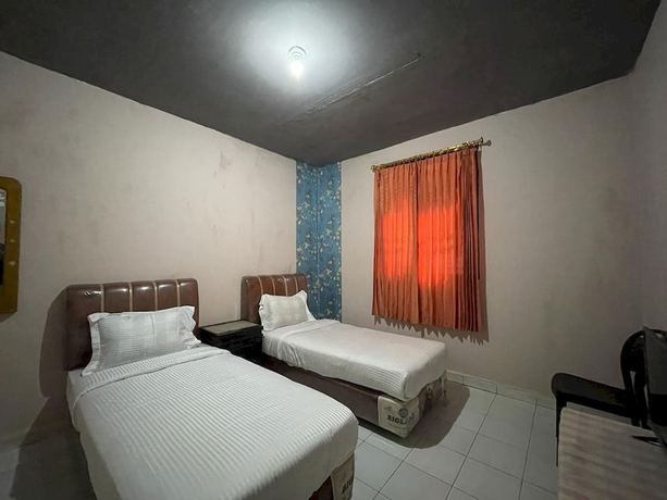 Imagen de la habitación del Hotel OYO 93292 Raudhatul Husna Homestay Syariah. Foto 11