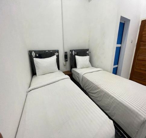 Imagen de la habitación del Hotel OYO 93311 Pesona Orange Homestay. Foto 12