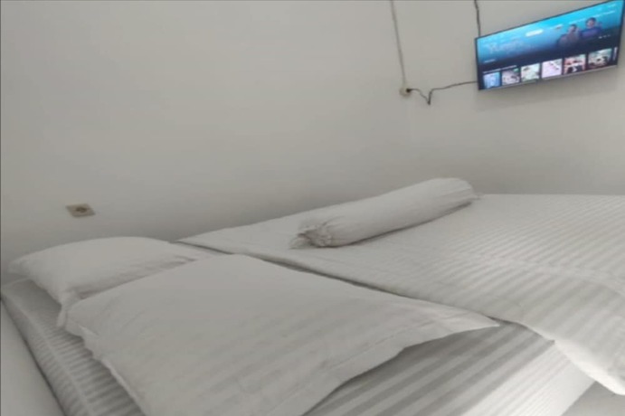 Imagen de la habitación del Hotel OYO 93526 Homely Syariah. Foto 8