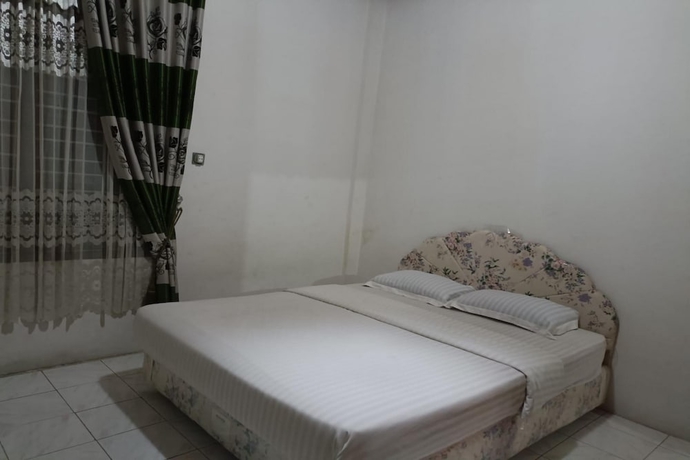 Imagen de la habitación del Hotel OYO 93706 Penginapan Syariah Hj. Kenan, Bungo Koto Tuo. Foto 16
