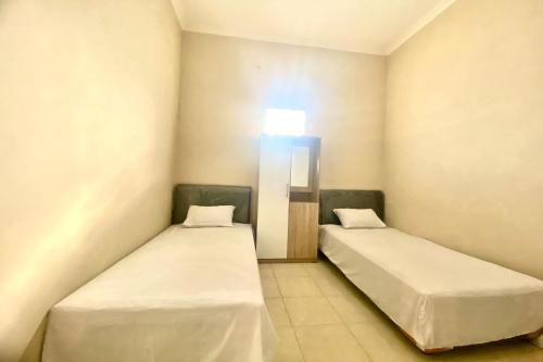 Imagen de la habitación del Hotel OYO 93838 Delia Inn Syariah. Foto 18