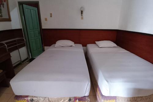 Imagen de la habitación del Hotel OYO 94082 Gurita. Foto 19