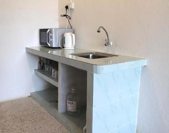 Imagen de la habitación del Hotel OYO HOME 90647 Mac Inn 94. Foto 9