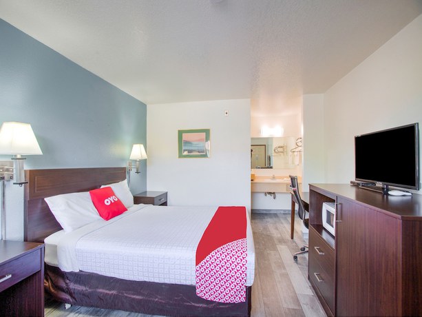 Imagen de la habitación del Hotel OYO Woodland and Suites. Foto 7