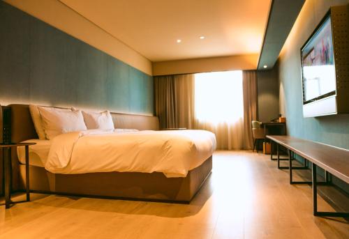 Imagen general del Hotel Orange - Taicang Nanyang Plaza. Foto 14