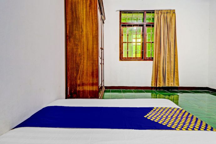 Imagen de la habitación del Hotel Oyo Homes 90849 Cibeunying Homestay Cibodas Maribaya. Foto 2