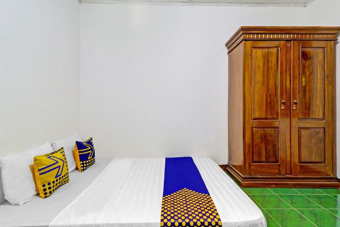 Imagen de la habitación del Hotel Oyo Homes 90849 Cibeunying Homestay Cibodas Maribaya. Foto 11