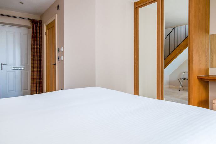 Imagen de la habitación del Hotel Oyo Orestone Manor. Foto 9