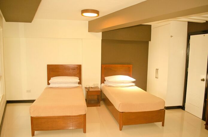 Imagen de la habitación del Hotel Palawan Palm Suites. Foto 25