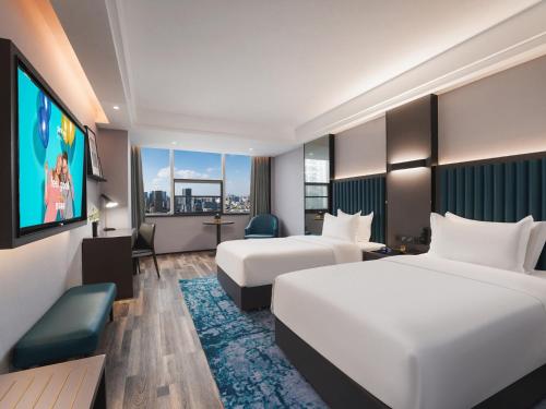 Imagen de la habitación del Hotel Park Inn by Radisson Hanzhong Central Square & High speed rail station. Foto 16