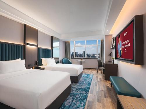Imagen de la habitación del Hotel Park Inn by Radisson Hanzhong Central Square & High speed rail station. Foto 18