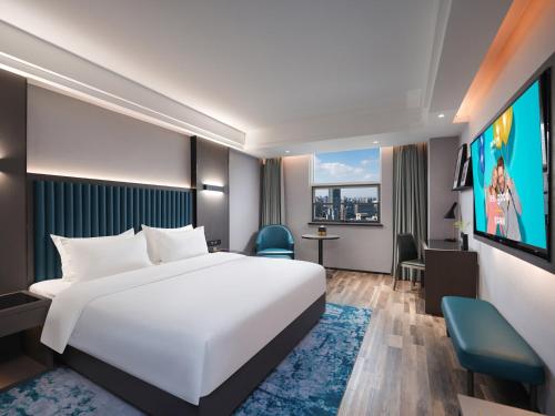 Imagen de la habitación del Hotel Park Inn by Radisson Hanzhong Central Square & High speed rail station. Foto 19