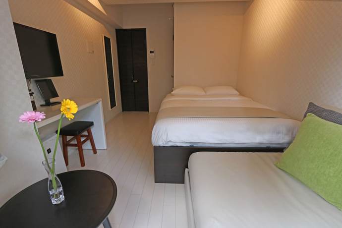 Imagen de la habitación del Hotel Petit Grande Homes. Foto 16