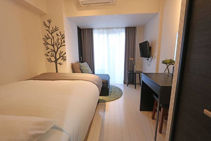 Imagen de la habitación del Hotel Petit Grande Homes. Foto 18
