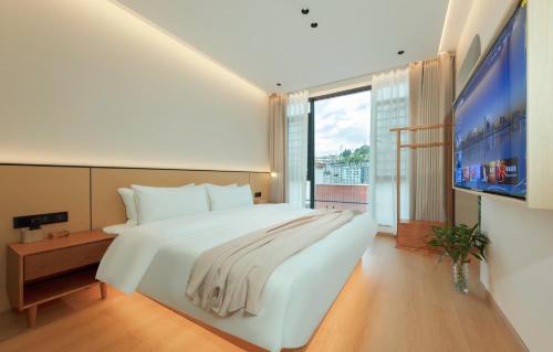 Imagen de la habitación del Hotel Phoenix Ancient City Courtyard凤凰古城庭院酒店. Foto 14