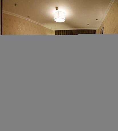 Imagen de la habitación del Hotel Phoenix Garden Hotel - Yantai. Foto 5