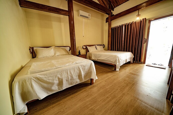 Imagen de la habitación del Hotel Phong Nha Coco Riverside Homestay. Foto 12