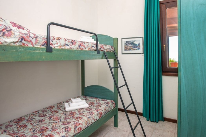 Imagen de la habitación del Hotel Pietre Rosse Residence Club Palinuro. Foto 8