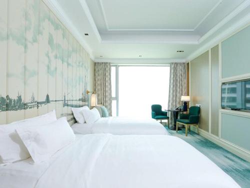 Imagen de la habitación del Hotel Plaza Carnival Qingdao. Foto 9