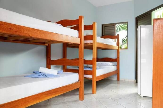 Imagen de la habitación del Hotel Pousada La Ferrugem Suites. Foto 15