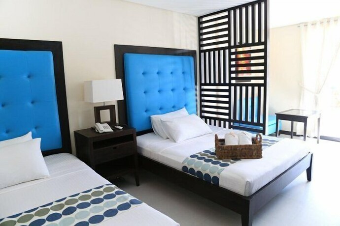 Imagen de la habitación del Hotel Puerto Del Sol Beach Resort. Foto 22