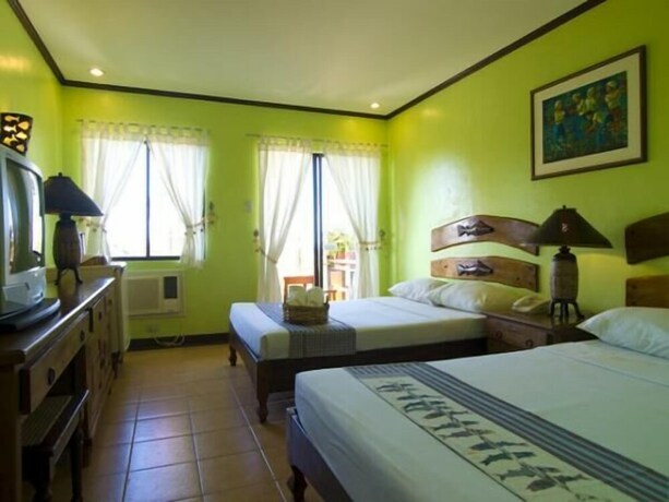 Imagen de la habitación del Hotel Puerto Del Sol Beach Resort. Foto 23
