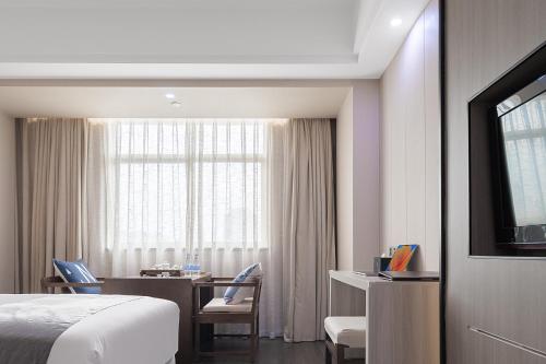 Imagen de la habitación del Hotel Puhui Tianchen Xiamen. Foto 16
