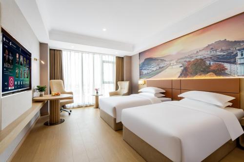 Imagen de la habitación del Hotel Pujue International. Foto 19