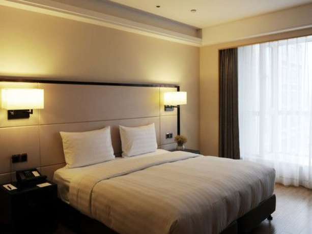 Imagen de la habitación del Hotel Pullman Qingdao Ziyue. Foto 13