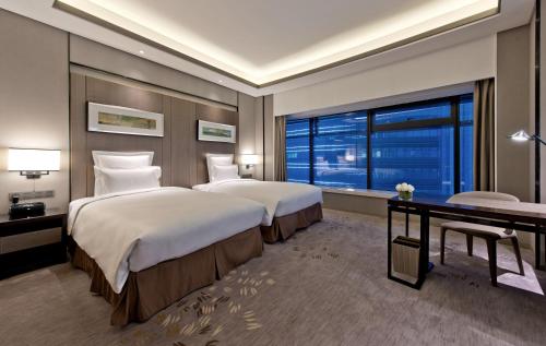 Imagen de la habitación del Hotel Pullman Shanghai Xuhui. Foto 11