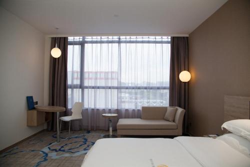 Imagen de la habitación del Hotel Qianhai Holiday. Foto 9