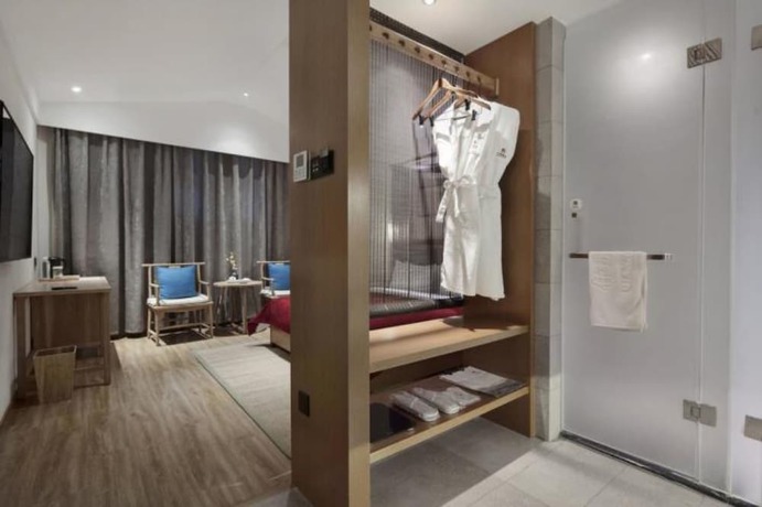 Imagen de la habitación del Hotel Qianna Bianyuan Hotel. Foto 19