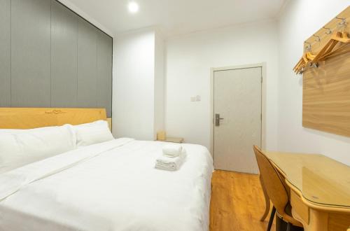 Imagen de la habitación del Hotel Qingdao Liuying Jieli - Qingdao Station Trestle Bridge Branch. Foto 11