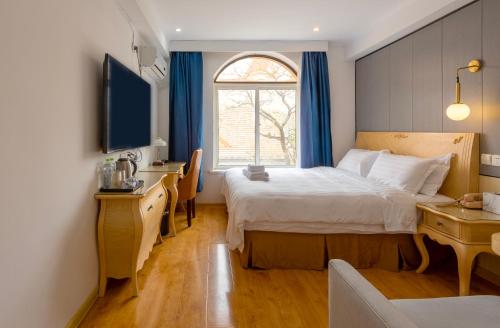 Imagen de la habitación del Hotel Qingdao Liuying Jieli - Qingdao Station Trestle Bridge Branch. Foto 19