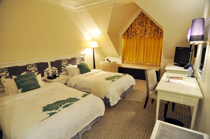 Imagen de la habitación del Hotel Qingdao The Castle. Foto 3