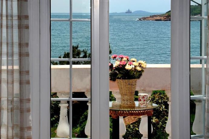 Imagen de la habitación del Hotel Qingdao Villa Inn Seaside. Foto 3