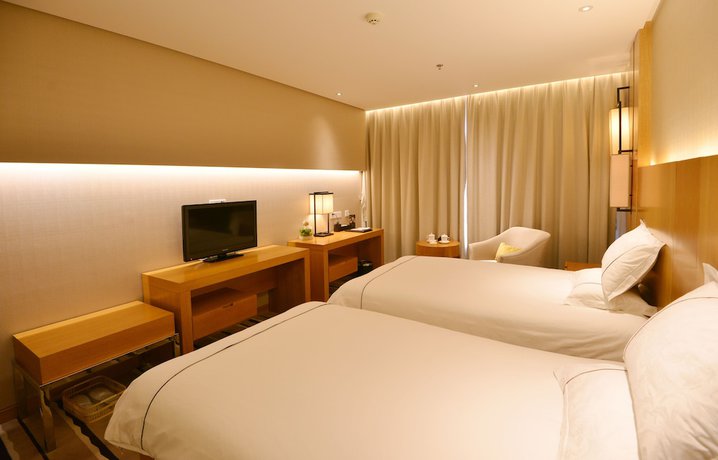 Imagen de la habitación del Hotel Qingdao Wushengguan Holiday. Foto 11