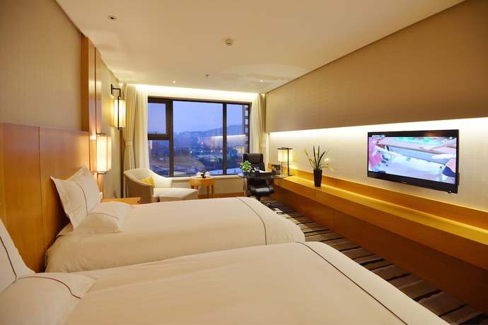 Imagen de la habitación del Hotel Qingdao Wushengguan Holiday. Foto 12
