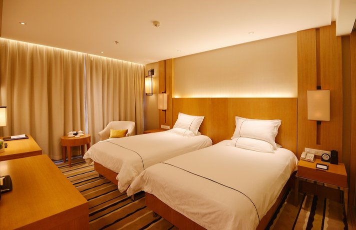 Imagen de la habitación del Hotel Qingdao Wushengguan Holiday. Foto 17