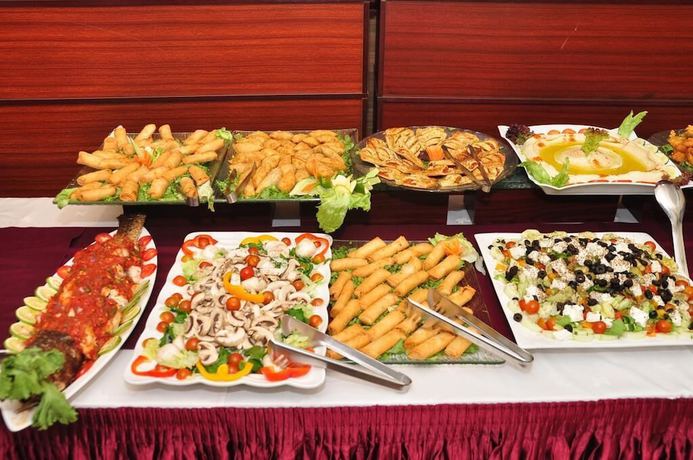 Imagen del bar/restaurante del Hotel Queensgate Continental And Suites. Foto 8