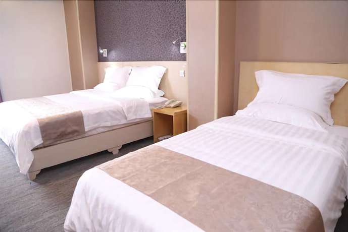 Imagen de la habitación del Hotel Ramada Encore By Wyndham Qingdao Shinan. Foto 6