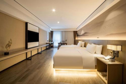 Imagen de la habitación del Hotel Ramada Encore by Wyndham Kunming Guandu. Foto 9